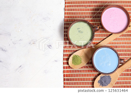 An assortment of colorful latte Japanese tea, golden turmeric, matcha, blue, pink moon milk. It has anti-inflammatory properties, improves immunity, alternative medicine 125631464