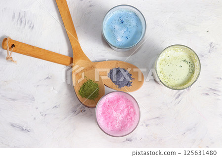 An assortment of colorful latte Japanese tea, matcha green, blue, pink moon milk. A fashionable healthy drink has anti-inflammatory properties, helps to reduce weight. 125631480