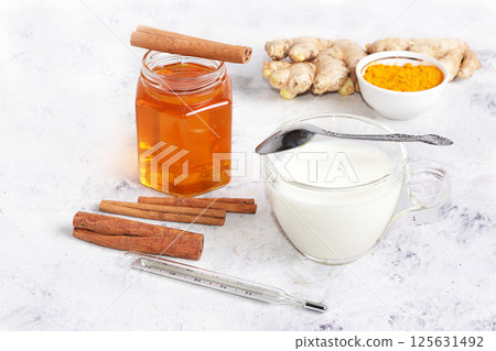 Healthy natural food for the treatment of flu and colds. Honey, milk, ginger and cinnamon to strengthen the immune system, protect against viruses, folk alternative medicine, selective focus. 125631492