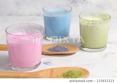 An assortment of colorful latte Japanese tea, matcha green, blue, pink moon milk. A fashionable healthy drink has anti-inflammatory properties, helps to reduce weight. 125631523