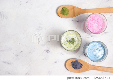 An assortment of colorful latte Japanese tea, matcha green, blue, pink moon milk. A fashionable healthy drink has anti-inflammatory properties, helps to reduce weight. 125631524