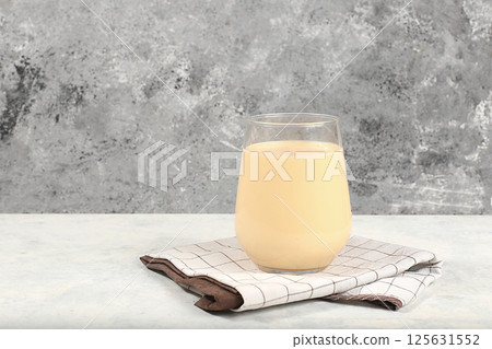 Indian almond yogurt lassi with spices, cinnamon and ginger on the old grunge background, probiotic fermented milk drink, natural dietary food, helps to combat infections and cancer, selective focus 125631552