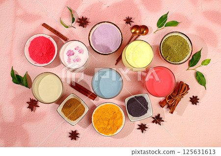 Various matcha tea lattes with milk on light background and matcha powder in cups. Traditional Indian trendy drink rich in antioxidants, used for weight loss and treatment, selective focus 125631613