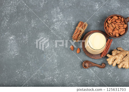 Indian almond yogurt lassi with spices, cinnamon and ginger on the old grunge background, probiotic fermented milk drink, natural dietary food, helps to combat infections and cancer, selective focus 125631703