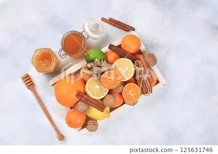 Healthy drink of golden turmeric latte with ginger root, cinnamon sticks, turmeric powder, a cup of milk and honey, spices for Ayurvedic medicine. Alternative medicine concept, has a strong 125631746