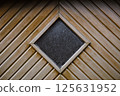 Close-up view of weathered painted metal folding door. 125631952