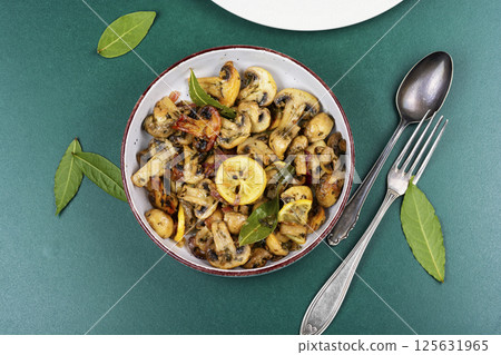 Delicious fried mushrooms in bowl. 125631965