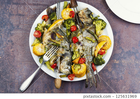 Two ready-made grilled fish. Two ready-made grilled fish. 125631969