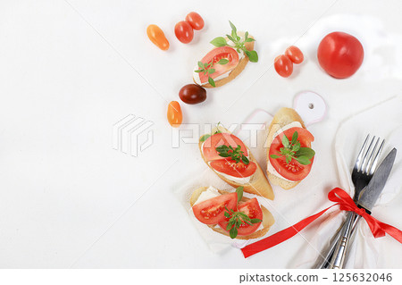 Caprese Bruschetta toast with mozzarella cheese, cherry tomatoes and fresh garden Basil.Traditional Italian food, healthy natural Breakfast, cholesterol-free and GMO-free, space for text, selective 125632046