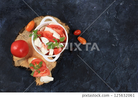 Caprese and Toast bruschetta with mozzarella cheese, cherry tomatoes and fresh garden basil. Traditional Italian food, healthy natural breakfast, cholesterol and GMO free, space for text, selective 125632061