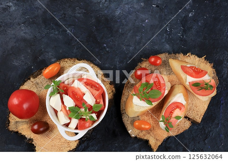 Caprese and Toast bruschetta with mozzarella cheese, cherry tomatoes and fresh garden basil. Traditional Italian food, healthy natural breakfast, cholesterol and GMO free, space for text, selective Caprese and Toast bruschetta with mozzarella cheese, cherry tomatoes and fresh garden basil. Traditional Italian food, healthy natural breakfast, cholesterol and GMO free, space for text, selective 125632064