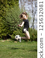 Girls playing with a soccer ball 125632081