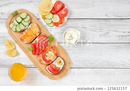 Diet vegan mini sandwiches with soft cottage cheese and fresh vegetables, cucumber, tomato, sweet pepper, egg and spices, Healthy breakfast with ingredients. healthy and natural food concept, 125632157