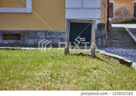 Signboard for a cafe showing direction on the street 125632183