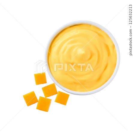 delicious cheddar cheese sauce in a white bowl isolated, top view. 125632213
