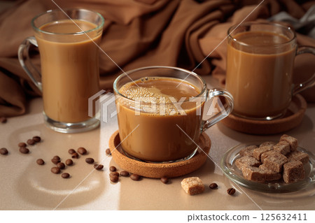 Latte with brown sugar on a beige background. Latte with brown sugar on a beige background. 125632411