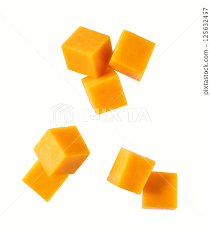 falling cheddar cheese cut into cubes isolated on white background, top view. 125632457