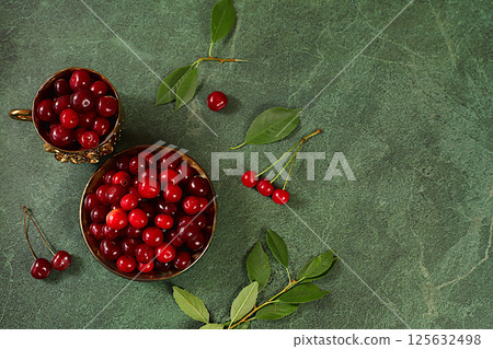 Summer fresh cherry berries on marble green background with leaves, banner for shops, rustic harvest, healthy natural food concept, breakfast with ingredients, cafe business card, selective focus 125632498