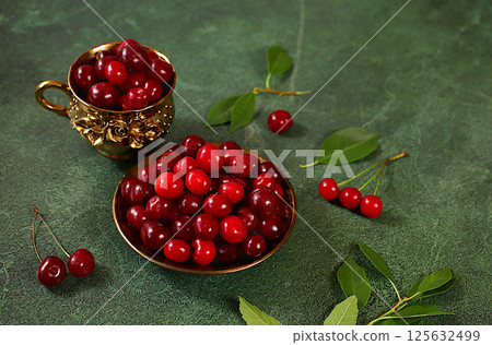 Summer fresh cherry berries on marble green background with leaves, banner for shops, rustic harvest, healthy natural food concept, breakfast with ingredients, cafe business card, selective focus 125632499