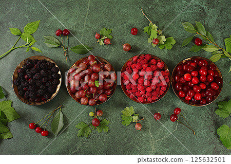 Summer fresh berries of cherry, raspberry, blackberry and gooseberry on marble green background with leaves, banner for shops, rustic harvest, healthy natural food concept, breakfast with ingredients, Summer fresh berries of cherry, raspberry, blackberry and gooseberry on marble green background with leaves, banner for shops, rustic harvest, healthy natural food concept, breakfast with ingredients, 125632501