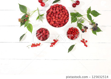 Summer fresh cherries, currants and raspberries on a light wooden background with leaves, banner and shop advertisement, village harvest, healthy natural food concept, breakfast with ingredients, cafe 125632514