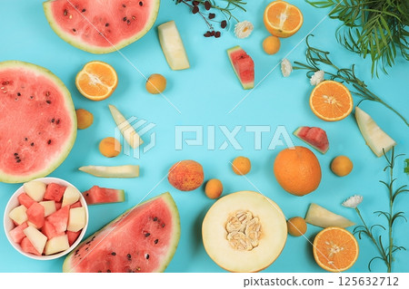Fresh tropical fruits and berries on a bright sunny table, watermelon and melon help to lose weight and cleanse the body, the concept of detox diet, natural and healthy nutrition, source of vitamins 125632712