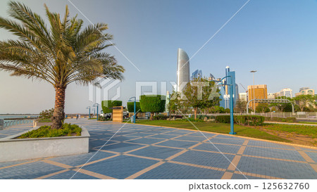 Corniche boulevard beach park along the coastline in Abu Dhabi timelapse hyperlapse with skyscrapers on background. 125632760