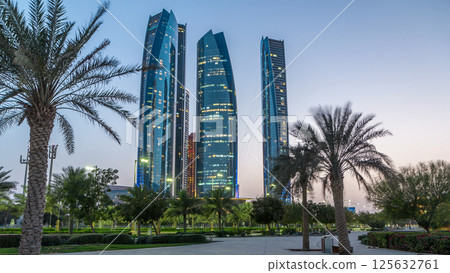 Skyscrapers of Abu Dhabi with Etihad Towers buildings day to night timelapse. 125632761