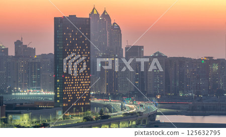 Buildings on Al Reem island in Abu Dhabi day to night timelapse from above. 125632795