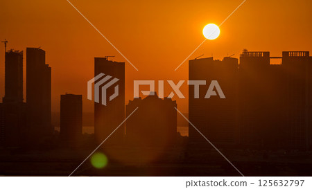 Buildings on Al Reem island in Abu Dhabi at sunset timelapse from above. 125632797