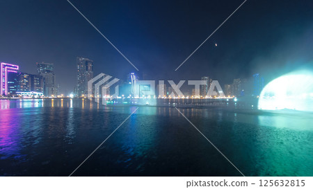 Evening Musical fountain show. Singing fountains in Sharjah timelapse, UAE 125632815