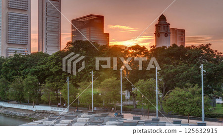 Sunset over Singapore skyscrapers skyline with white Anderson Bridge near esplanade park timelapse. Sunset over Singapore skyscrapers skyline with white Anderson Bridge near esplanade park timelapse. 125632915