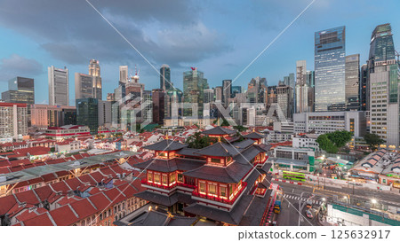 The Buddha Tooth Relic Temple comes alive at night in Singapore Chinatown day to night timelapse, with the city skyline in the background. The Buddha Tooth Relic Temple comes alive at night in Singapore Chinatown day to night timelapse, with the city skyline in the background. 125632917