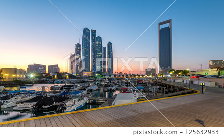 Al Bateen marina Abu Dhabi day to night timelapse with modern skyscrapers on background Al Bateen marina Abu Dhabi day to night timelapse with modern skyscrapers on background 125632933