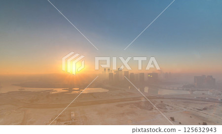 Abu Dhabi city skyline with skyscrapers at sunrise from above timelapse 125632943