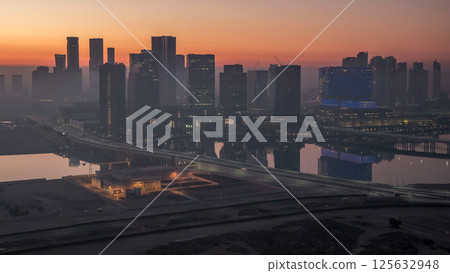 Abu Dhabi city skyline with skyscrapers before sunrise from above night to day timelapse 125632948