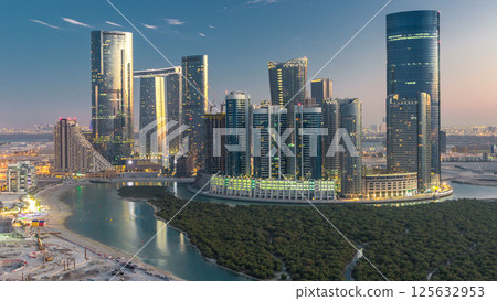 Buildings on Al Reem island in Abu Dhabi day to night timelapse from above. 125632953