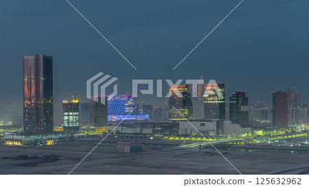 Buildings on Al Reem island in Abu Dhabi night to day timelapse from above. Buildings on Al Reem island in Abu Dhabi night to day timelapse from above. 125632962