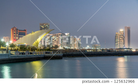 Promenade in Abu Dhabi illuminated at dusk, day to night timelapse. Promenade in Abu Dhabi illuminated at dusk, day to night timelapse. 125632966