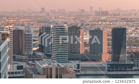 Dubai's business bay towers at evening aerial timelapse. 125632975