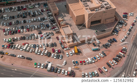 Aerial view full cars at large outdoor parking lots timelapse in Dubai, UAE. Aerial view full cars at large outdoor parking lots timelapse in Dubai, UAE. 125632992
