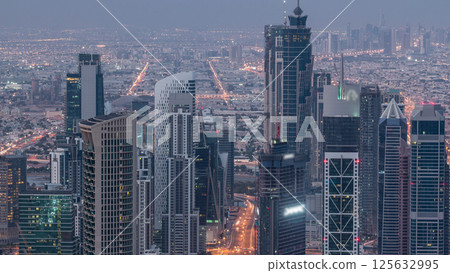 Dubai Downtown skyline futuristic cityscape with many skyscrapers and Burj Khalifa aerial night to day timelapse. 125632995