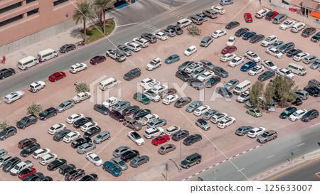 Aerial view full cars at large outdoor parking lots timelapse in Dubai, UAE. Aerial view full cars at large outdoor parking lots timelapse in Dubai, UAE. 125633007