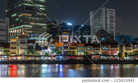 Singapore quay with tall skyscrapers in the central business district on Boat Quay night timelapse hyperlapse 125633041
