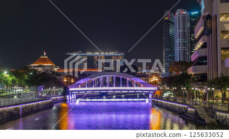 Skyline of Singapore financial district behind Elgin Bridge and the Singapore River night timelapse hyperlapse 125633052