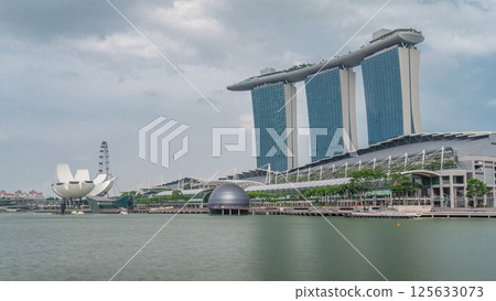 Fifty-five storeys high Marina Bay Sands Hotel dominates the skyline at Marina Bay in Singapore timelapse hyperlapse. 125633073