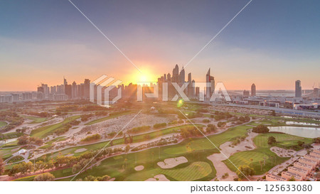 Dubai Marina skyscrapers and golf course sunset timelapse, Dubai, United Arab Emirates 125633080