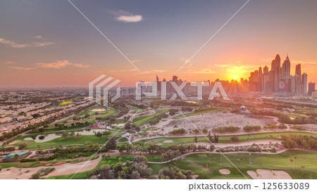 Dubai Marina skyscrapers and golf course sunset timelapse, Dubai, United Arab Emirates Dubai Marina skyscrapers and golf course sunset timelapse, Dubai, United Arab Emirates 125633089