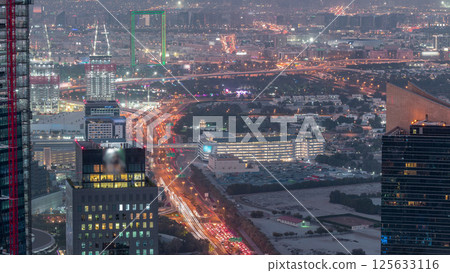 Aerial view to financial and zabeel district day to night timelapse with traffic and under construction building with cranes from downtown Aerial view to financial and zabeel district day to night timelapse with traffic and under construction building with cranes from downtown 125633116