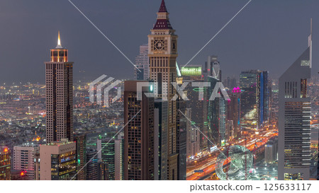 Skyline of the buildings of Sheikh Zayed Road and DIFC aerial day to night timelapse in Dubai, UAE. 125633117